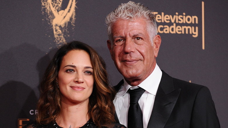 Asia Argento and Anthony Bourdain posing for pictures