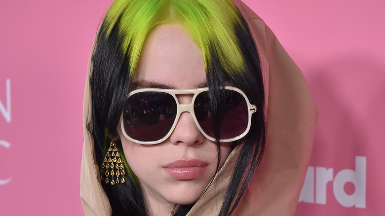 Billie Eilish wears sunglasses on the red carpet