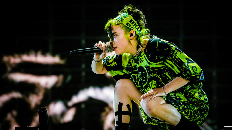 Billie Eilish performing in lime green outfit