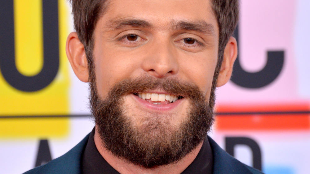 Thomas Rhett with a full beard, smiling 