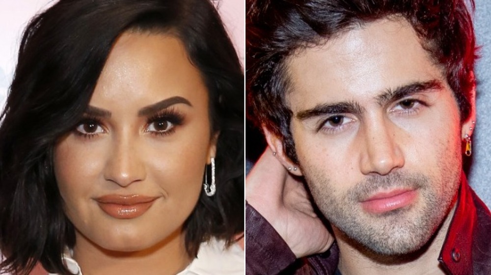 Demi Lovato smiling, Max Ehrich posing