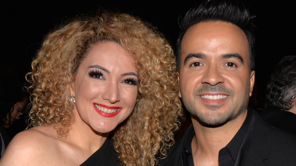 Erika Ender and Luis Fonsi posing together at an event