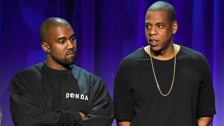 kanye west and jay-z stand on stage