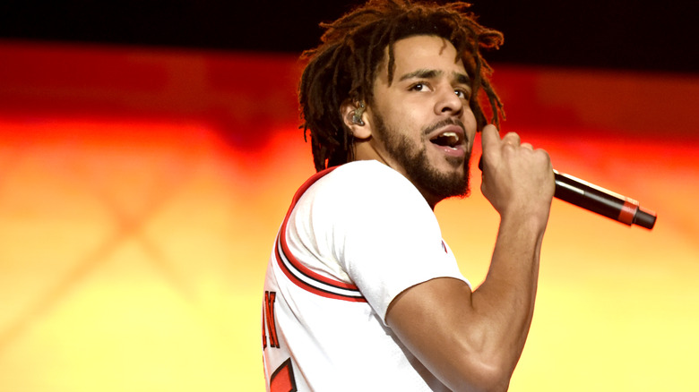 J. Cole performing on stage