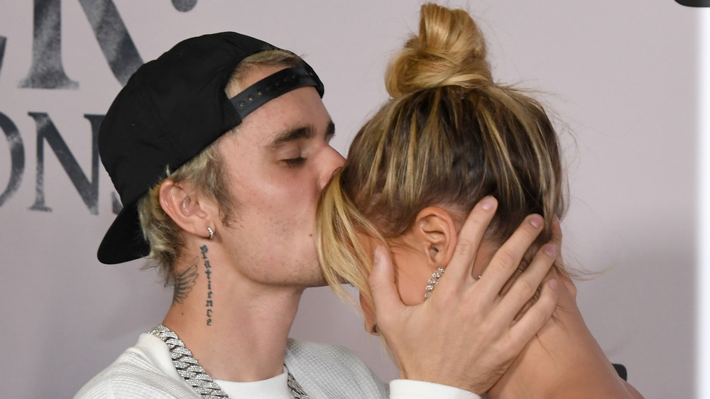 Justin Bieber kissing wife Hailey Baldwin on the forehead 