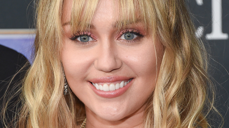 Miley Cyrus smiles on the red carpet