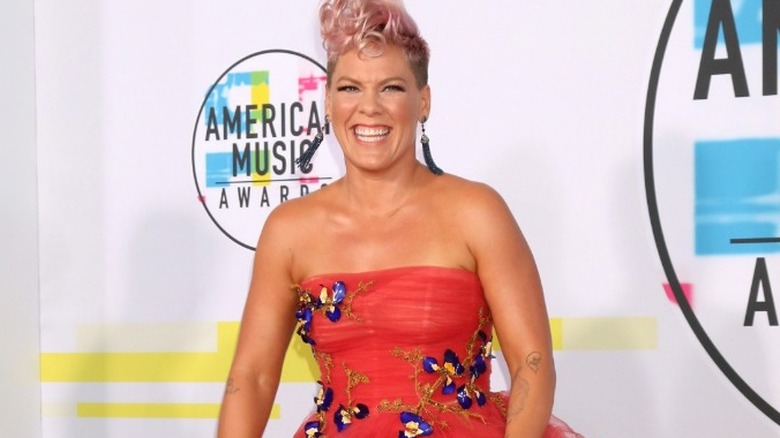 Pink wearing red strapless dress