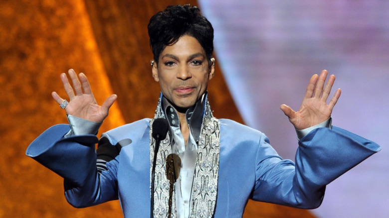 Prince accepts an award on stage