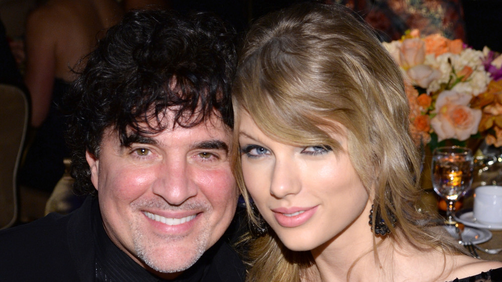 Scott Borchetta and Taylor Swift posing together for cameras