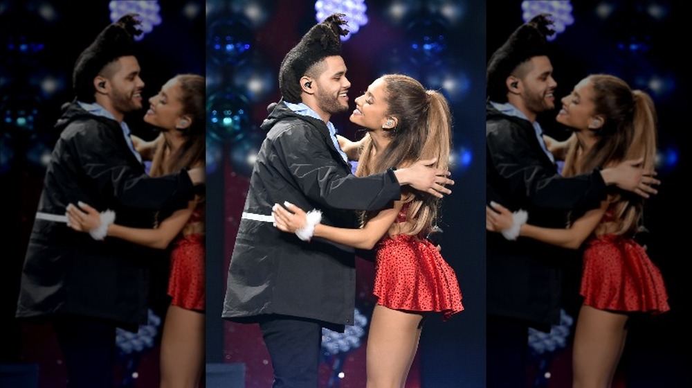 The Weeknd and Ariana Grande hugging onstage