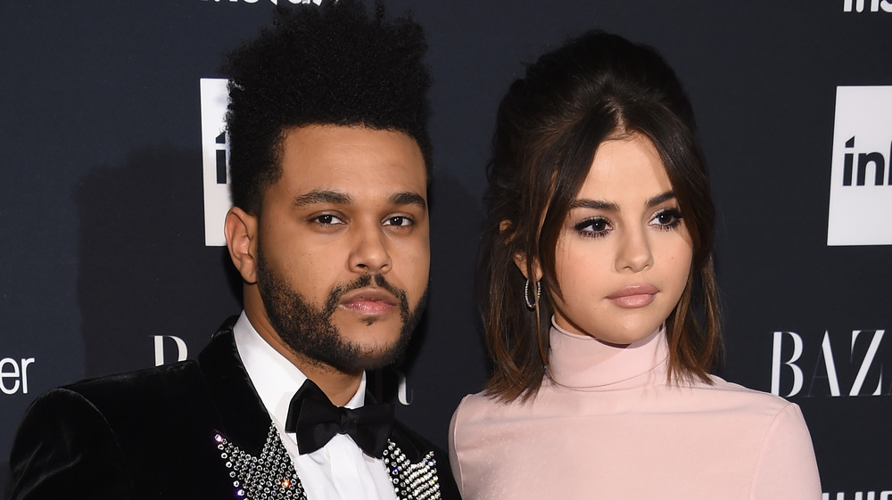 The Weeknd and Selena Gomez posing for cameras