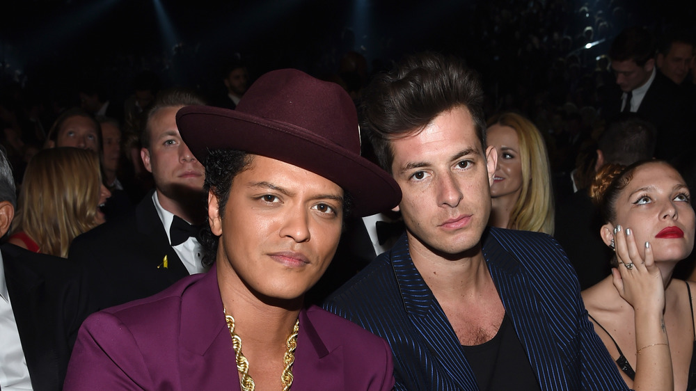 Bruno Mars and Mark Ronson posing together at an event
