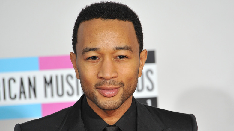 John Legend posing at an event 