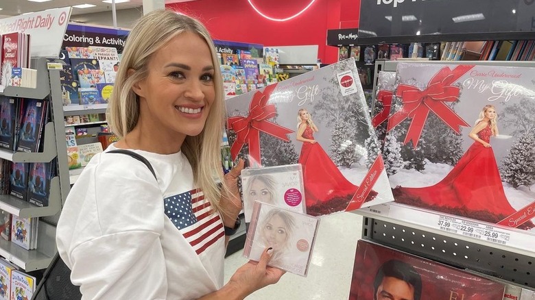 Carrie Underwood holding Christmas album