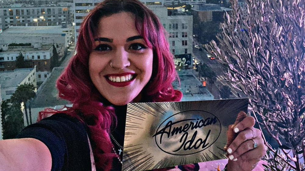 Andrea Valles holding an American Idol card