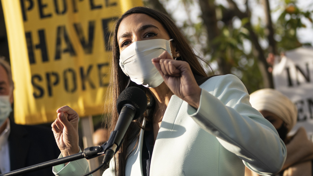 Alexandria Ocasio-Cortez speaking in mask