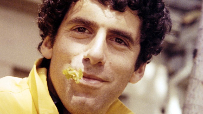 Elliott Gould with a flower in mouth