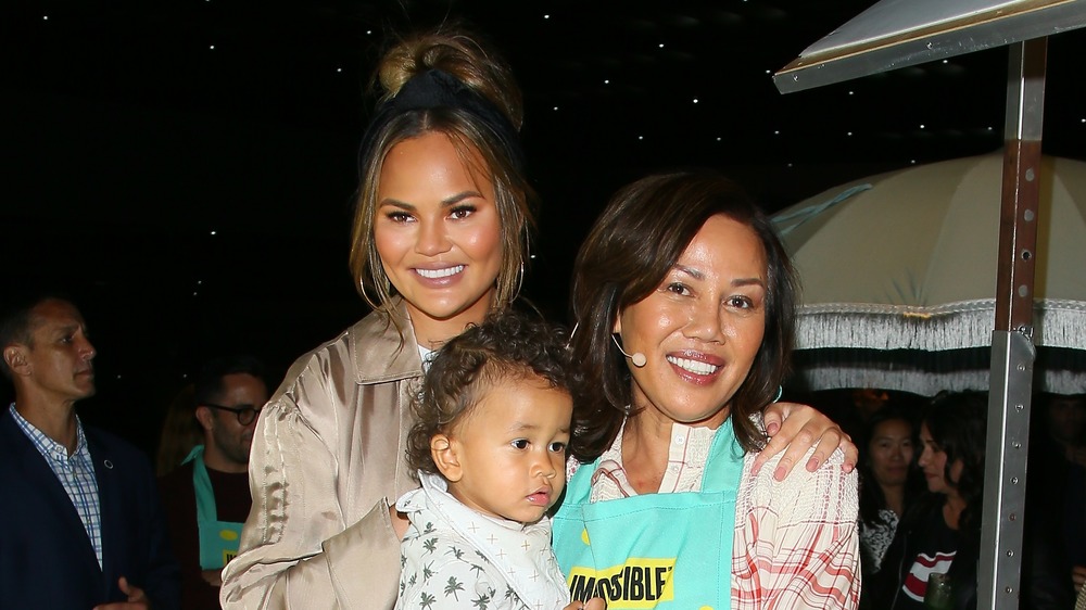 Chrissy Teigen, Miles and Vilailuck Teigen outside 