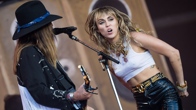 Billy Ray and Miley Cyrus perform onstage