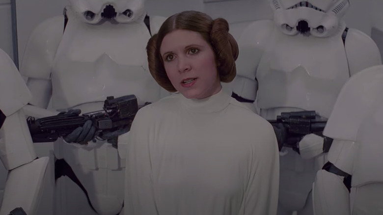 Carrie Fisher as Princess Leia with storm troopers