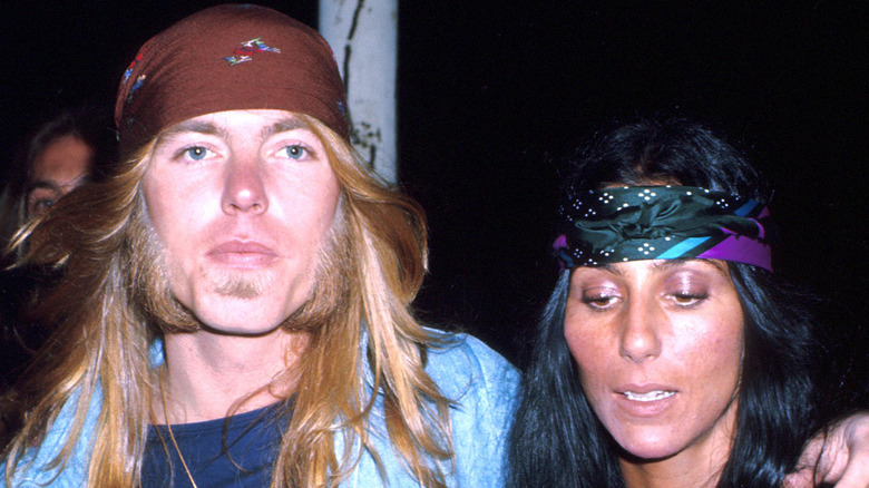 Gregg Allman and Cher walking