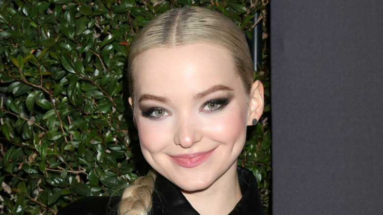 Dove Cameron smiling with hair braided