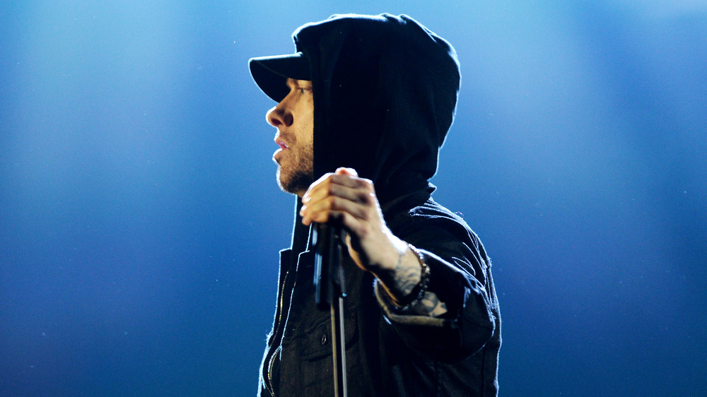 Eminem holds a microphone stand