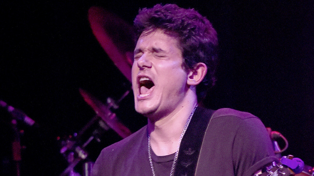 John Mayer pulling a face while singing