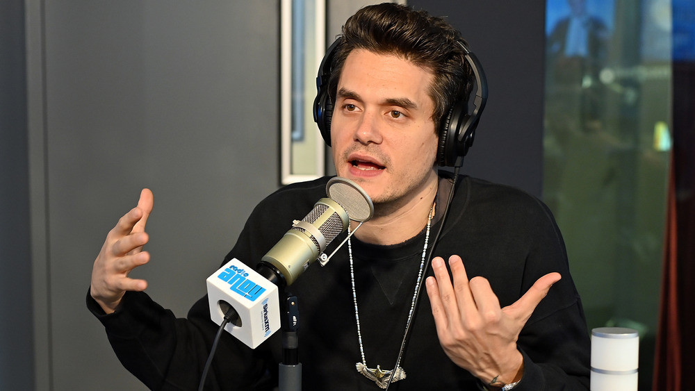 John Mayer speaking and gesturing with his hands on Radio Andy