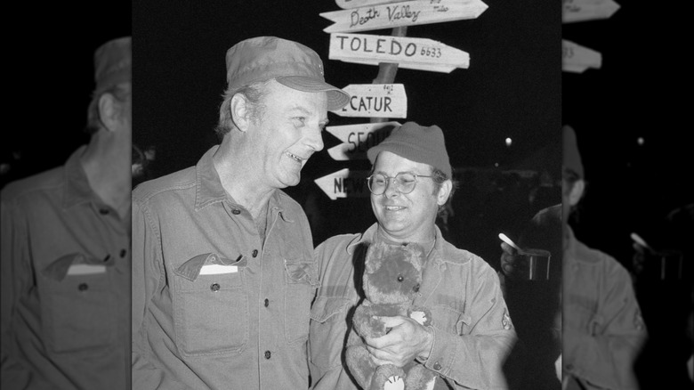 Larry Linville and Gary Burghoff stand on the set of M*A*S*H