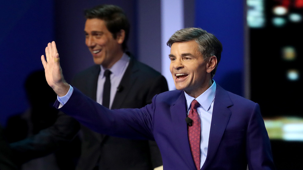 George Stephanopoulos waving in front of David Muir