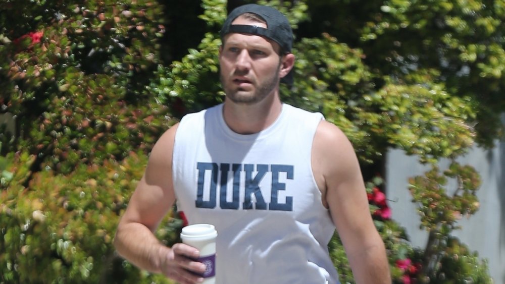 Brian Hickerson walking while holding a coffee cup