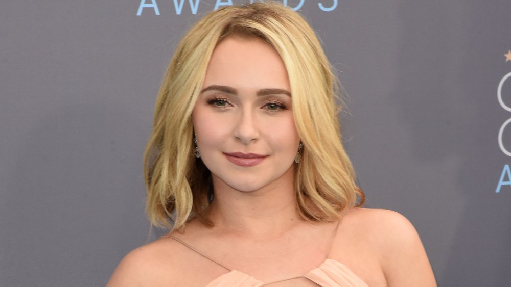 Hayden Panettiere posing on the red carpet with a neutral expression