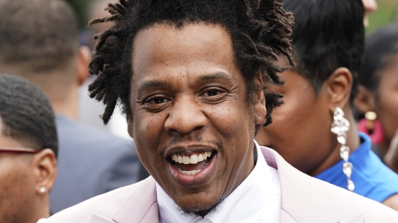 Jay-Z smiles wearing blazer