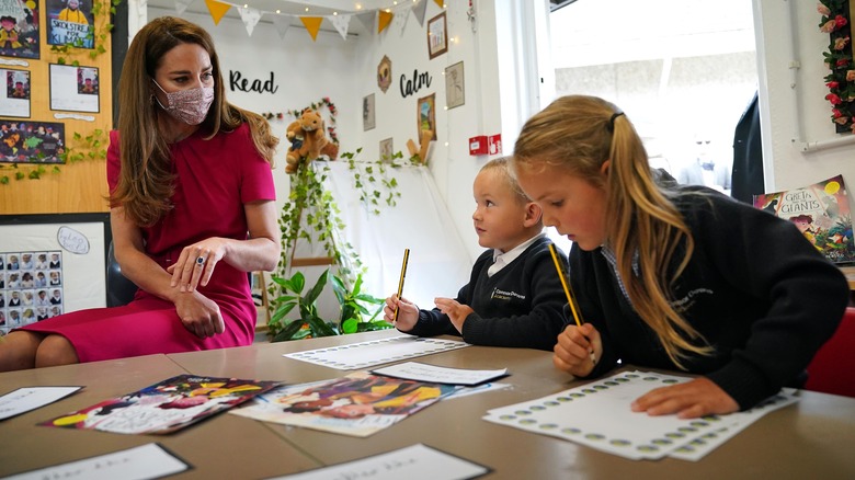 Kate Middleton talks with children in a classroom in 2021