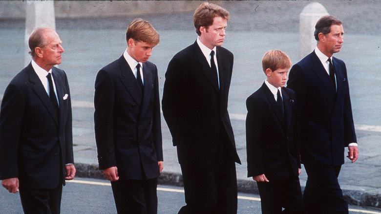 Prince William and Prince Harry walking behind Princess Diana's casket