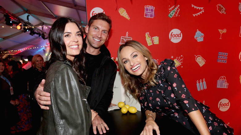 Katie Lee Biegel and husband smiling at Food Network celebration