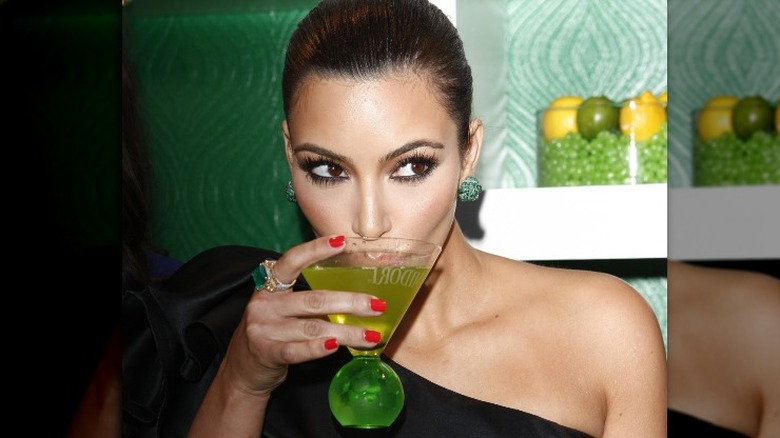 Kim Kardashian drinking a cocktail