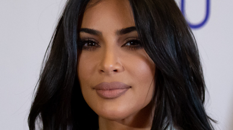 Kim Kardashian smiling slightly