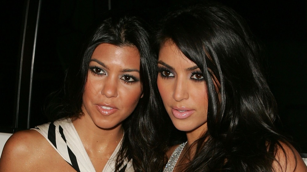 Kourtney Kardashian and Kim Kardashian posing early 2000's