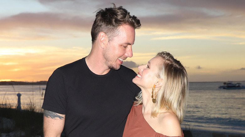 Dax Shepard looking down and smiling at Kristen Bell