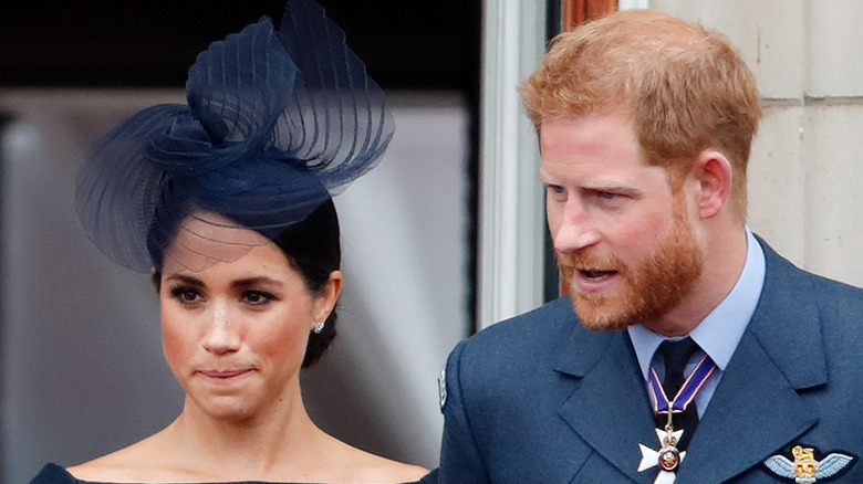 Meghan Markle and Prince Harry with serious expressions