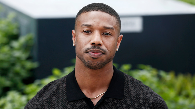 Michael B. Jordan, looking upset, outside at a 2018 event