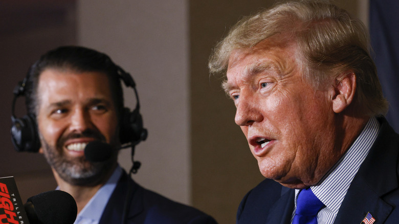  Former President Donald Trump speaks as Donald Trump Jr. looks before fight between Holyfield and Belfort Sept. 2021