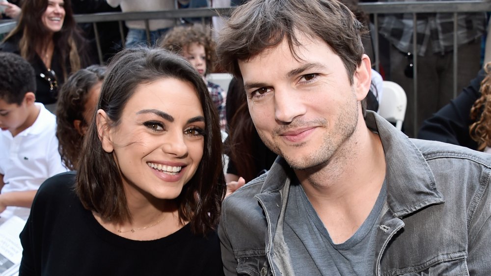 Mila Kunis, Ashton Kutcher posing at an event together