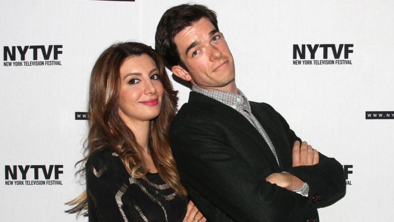 Nasim Pedrad and John Mulaney posing on red carpet