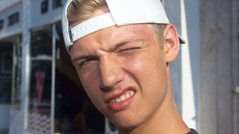 Nick Carter posing in backwards hat