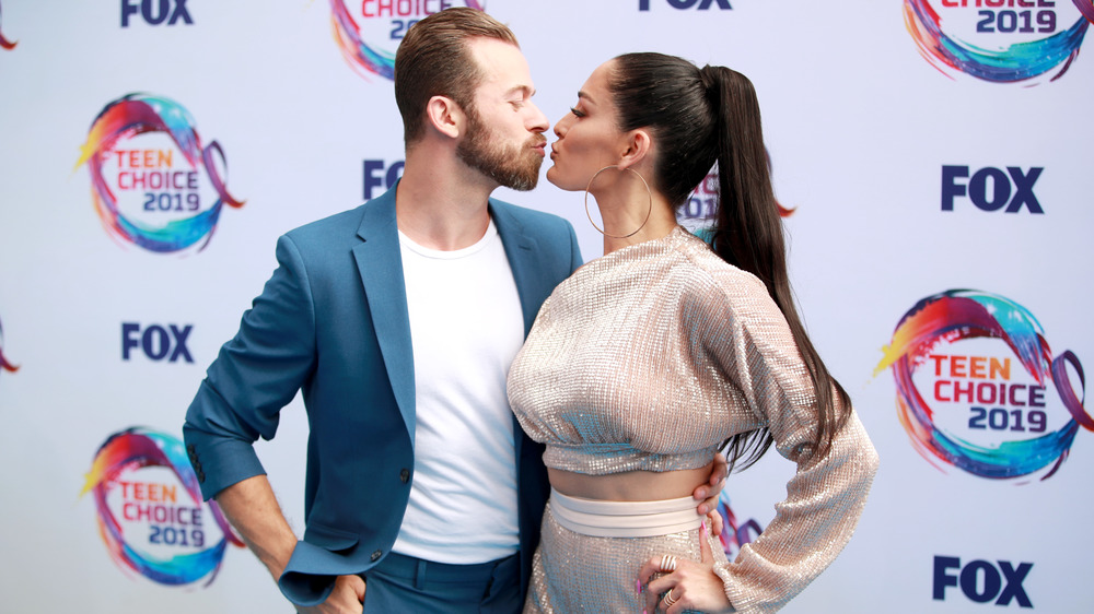 Artem Chigvintsev and Nikki Bella kissing on red carpet