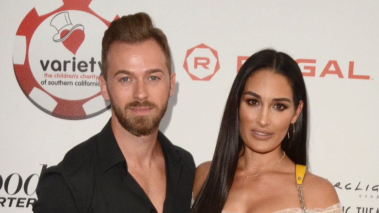 Artem Chigvintsev and Nikki Bella at Variety Charity Poker & Casino Night in 2019