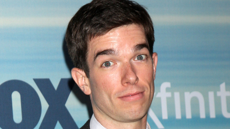 John Mulaney head tilted